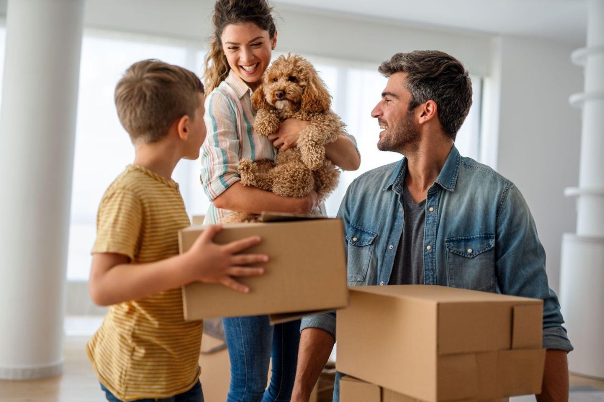 A family with an ESA dog moving into their new rental home, unpacking the boxes with the mother lovingly holding her ESA